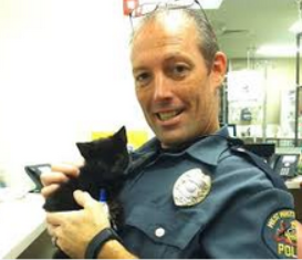 Cop Holding Cat